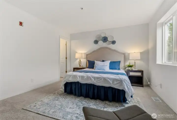 This primary bedroom has just the right width for a queen bed with two large end tables, plus the bonus everyone loves: its own private ensuite.