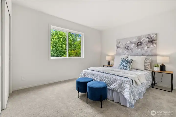 The second bedroom looks out to greenery, giving this room a calm little backdrop for work, rest, or whatever you need next.
