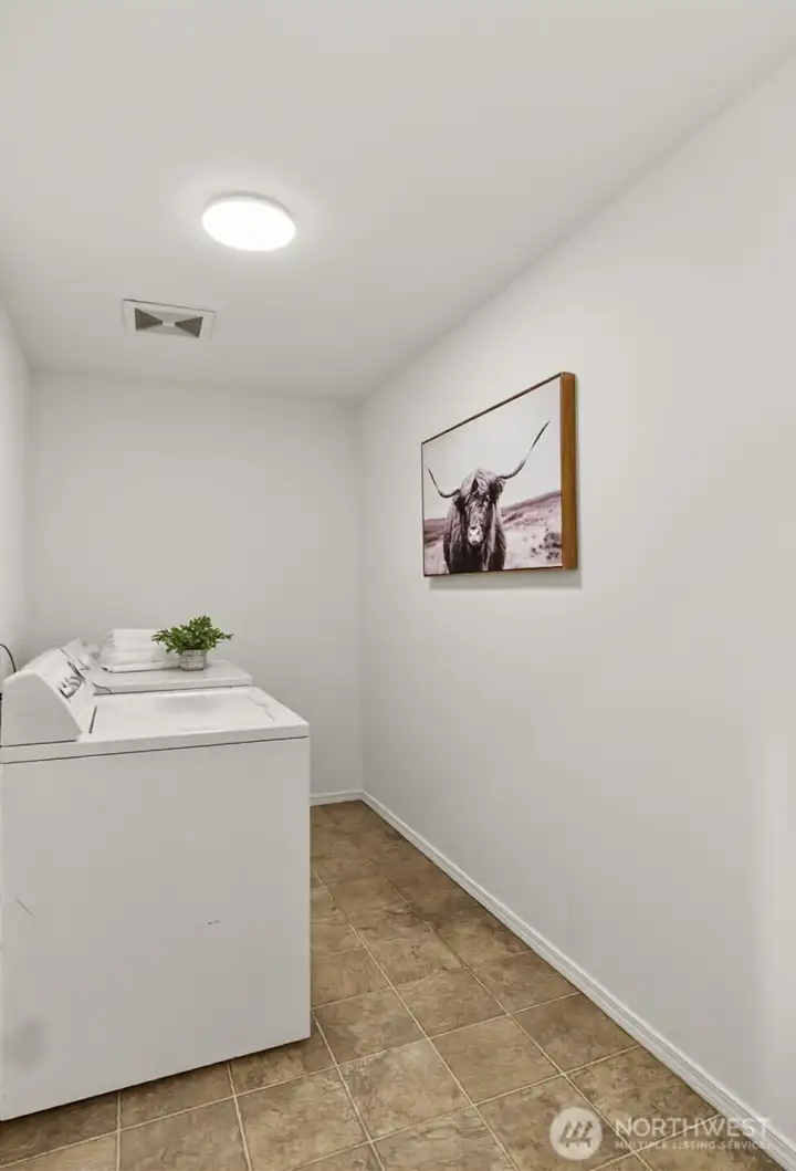 Now this is a laundry room. Hampers, folding table, hanging rack, overflow storage... there’s actual room to work with here.