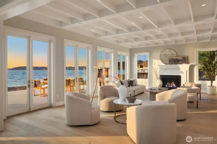 Beamed ceilings, beautifully crafted woodwork, and wide-plank hardwood floors—echoing the driftwood along the shore—blend with a clean, sea-inspired palette to create an uplifting sense of comfort, ease, and effortless coastal living.