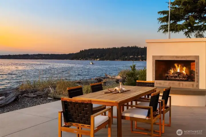 Designed to blend seamlessly with its natural seaside surroundings—your own private backyard—the home opens onto a built-in patio with a cozy fireplace, the perfect setting for long, lingering al fresco dinners.