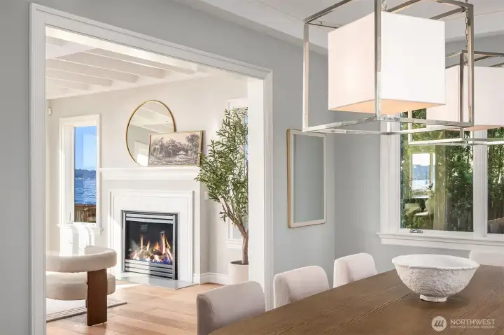 A closer view from the dining room reveals the classically designed living room fireplace, where timeless detailing meets an inviting sense of warmth and comfort.
