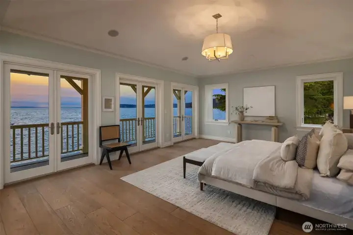 Welcome to an extraordinary primary ensuite sanctuary. Secluded from the other bedrooms, this vaulted retreat—framed by walls of French doors that open onto a covered deck—enjoys a front-row seat to iconic views, evoking the feeling of being aboard a ship.