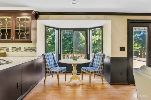 Dine near the bay window of this kitchen nook and you can see the golf course through the privacy trees.