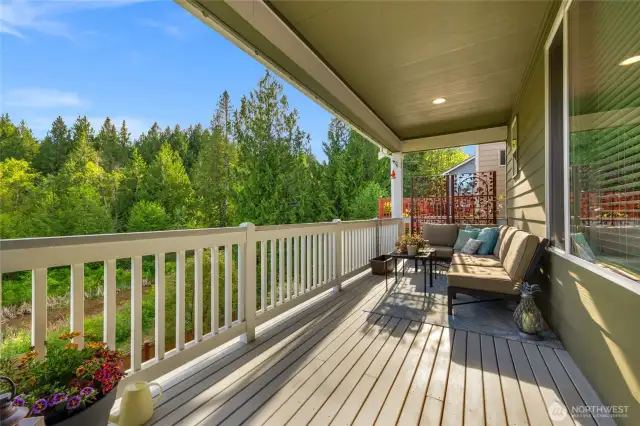 Lovely covered back deck, with views of the greenbelt area