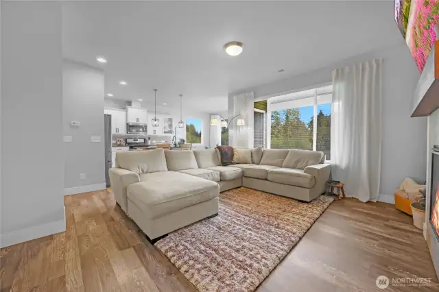 Open concept family room just off of the kitchen, warm and inviting greenbelt view from the large window