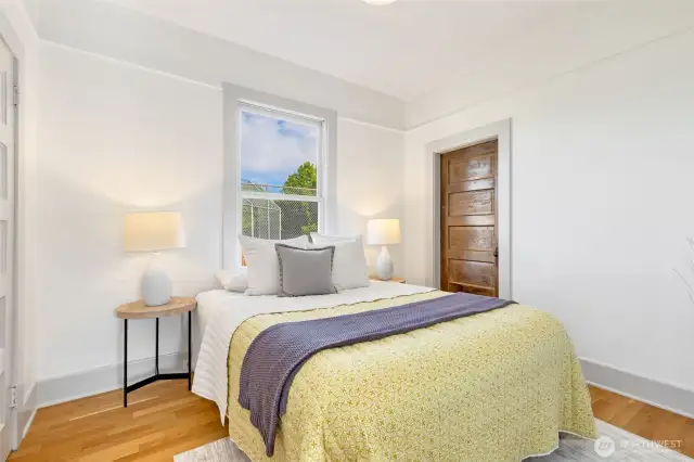 Main floor bedroom with hardwood floors.