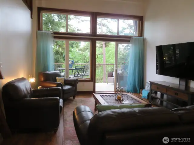 Living room with vaulted ceilings that extend to 14 feet.