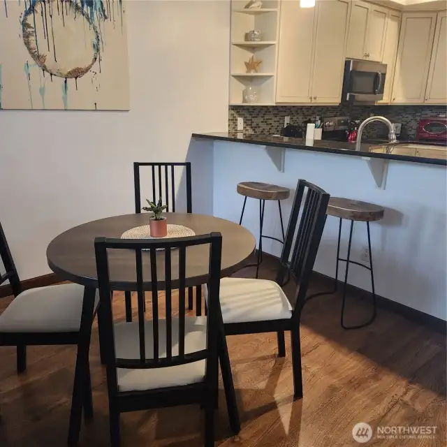 Dining area between living room and ktichen eating bar.