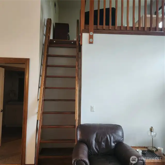 Up the ladder to the loft.  This could be utilized as an unoffical sleeping area, study room/office, art studio, exercise room.....