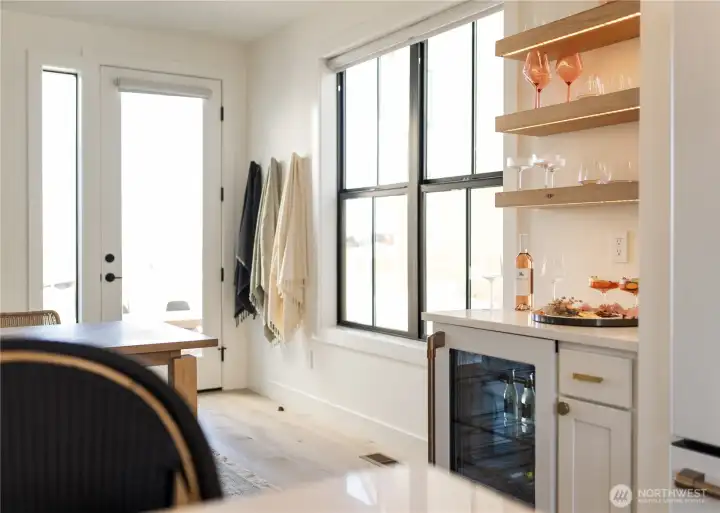 The Bar: Accent lit open shelving, quartz counter tops, Cafe® Bevy Fridge with LED backlighting, Cafe® coffee maker.