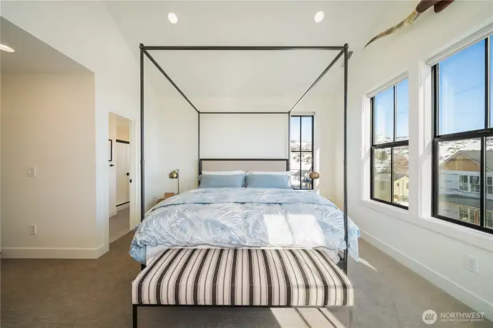 The Primary Suite: Four Seasons® mattress, designer furniture, and newly installed drapery (not shown).