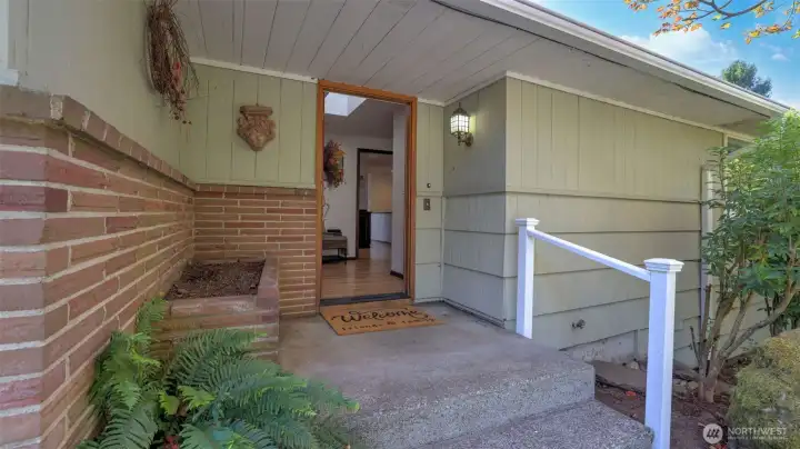 Inviting front entry with brick accents and a welcoming touch.