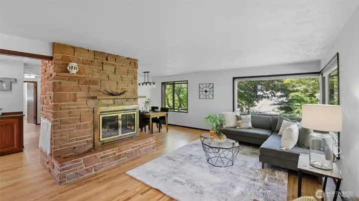 Charming floor-to-ceiling stone fireplace adds warmth and character to the living room.