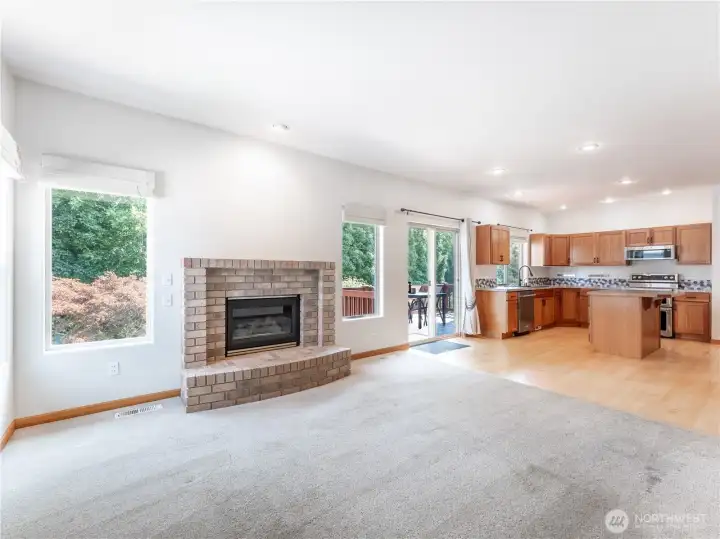 Propane Fireplace is the Focal Point in the Light Filled Family Room that Adjoins the Kitchen