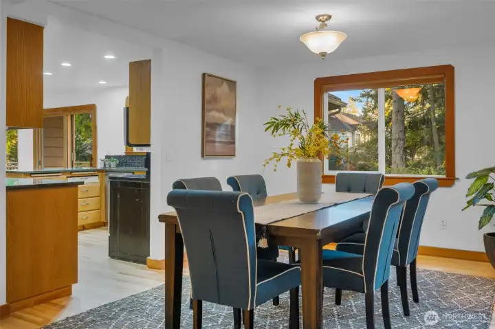 Dining room with the kitchen to the left. Overlooks the side and back garden and has plenty of light coming in!