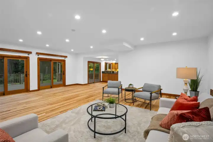 Great room overlooking the back garden with multiple sliders to access. Kitchen to the right