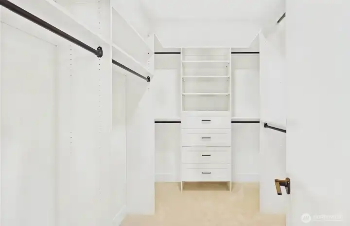 Primary bedroom walk in closet