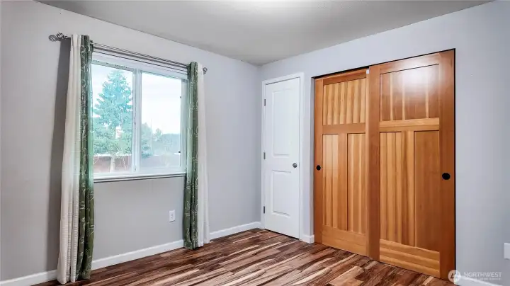 Bedroom with sliding closet doors offering generous storage and a clean, functional layout.