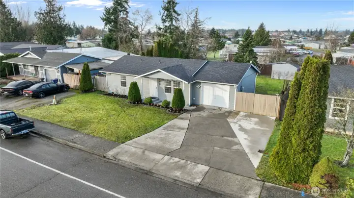 Front exterior aerial view featuring driveway, front yard, and single-level home layout.