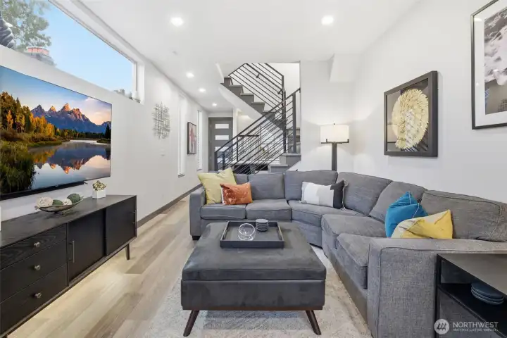 Light-filled open-concept living space with wide-plank flooring, modern finishes, and seamless flow ideal for everyday living and entertaining.