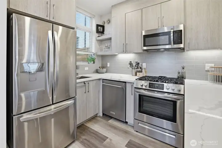 Functional kitchen layout with ample storage, open shelving, and clean modern aesthetic.