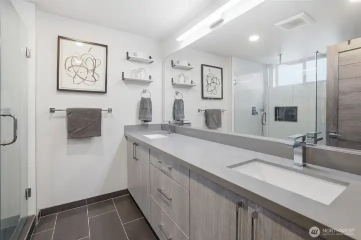Spa-inspired bathroom with double vanity, modern fixtures, and large walk-in shower.
