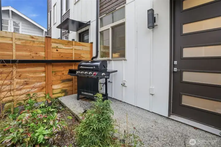 Ground-level patio space ideal for grilling, container gardening, or a cozy outdoor seating area.