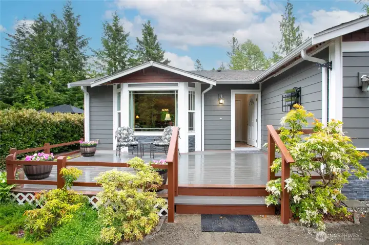 Large front deck with gardens all around.