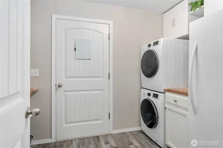 Laundry room. The cabinet on right is not attached and could be moved to put a washer and dryer side by side.