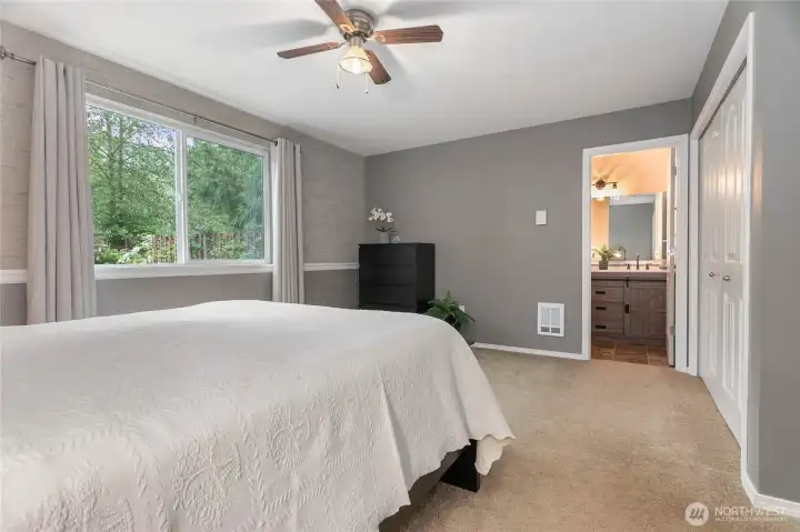 Spacious primary bedroom looking towards primary bathroom
