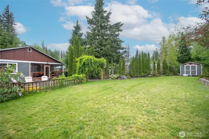 Large grassy acreage behind back patio area...