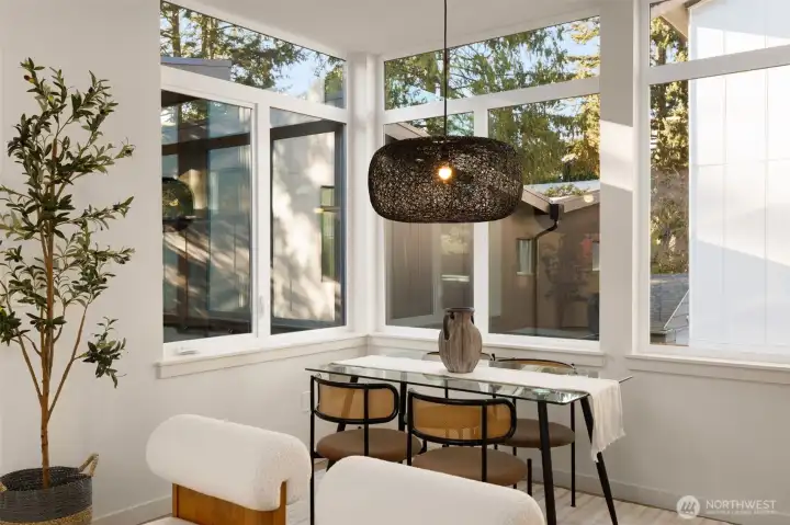 Dedicated dining space basked in natural light from full height windows