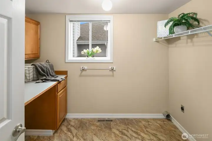 Large Utility Room with storage, sink, and folding area!