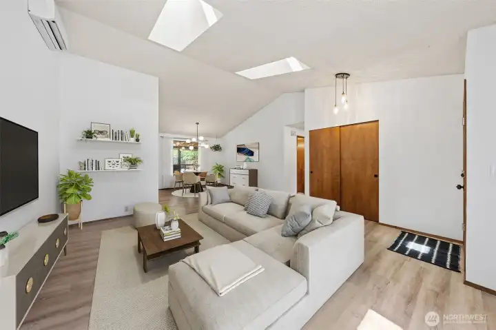 Spacious living area with convenient entry storage and an open flow into the dining room creates easy everyday living. (Virtually Staged)