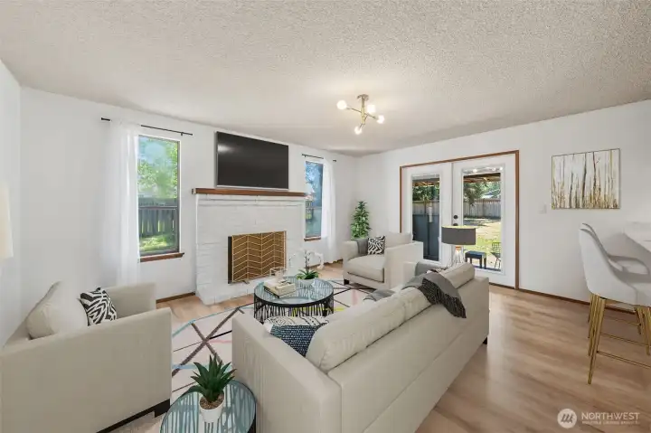 Another look at the inviting family room and classic wood-burning fireplace, ready for Northwest evenings. (Virtually Staged)