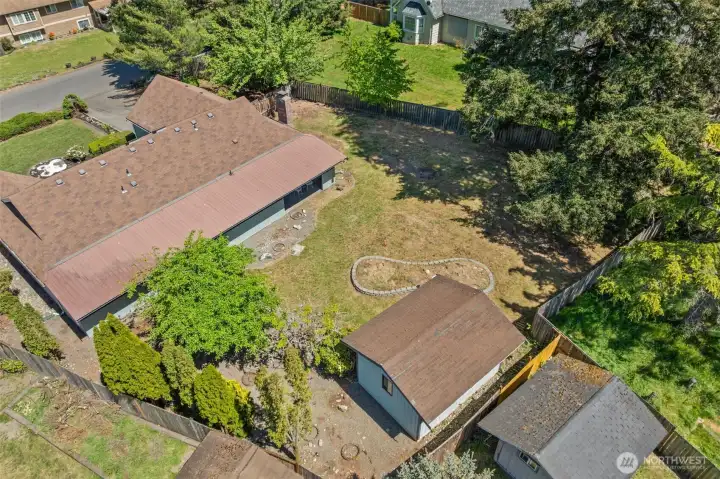 Overhead view showcases the expansive backyard, storage shed, and room to dream big.