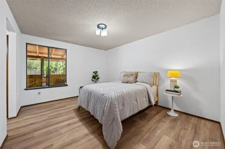 Spacious primary bedroom offers comfort, privacy, and room to truly unwind.