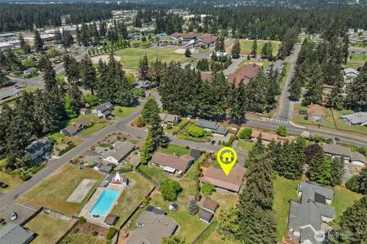 Drone view highlights the home’s close proximity to both the community pool and the elementary school just across the street.