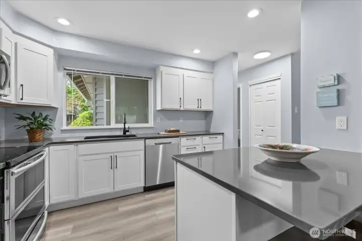 Stunningly renovated kitchen featuring all-new smart Samsung appliances, sleek custom cabinetry, modern quartz countertops, and an undermount sink. The expanded layout includes a functional peninsula that offers comfortable seating for two, perfect for casual dining or morning coffee. Stunningly renovated kitchen featuring all-new smart Samsung appliances, sleek custom cabinetry, modern quartz countertops, and an undermount sink. The expanded layout includes a functional peninsula that offers comfortable seating for two, perfect for casual dining or morning coffee.