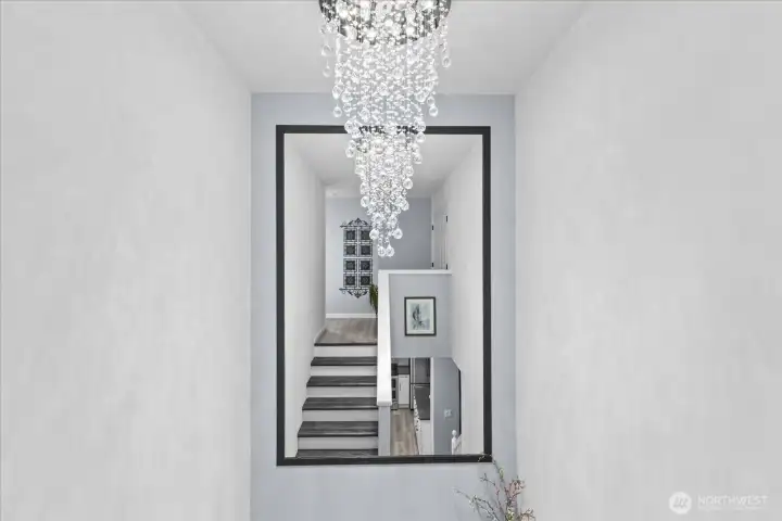 Crystal chandelier, oversize mirror greet you on your way up or down the staircase Crystal chandelier, oversize mirror greet you on your way up or down the staircase