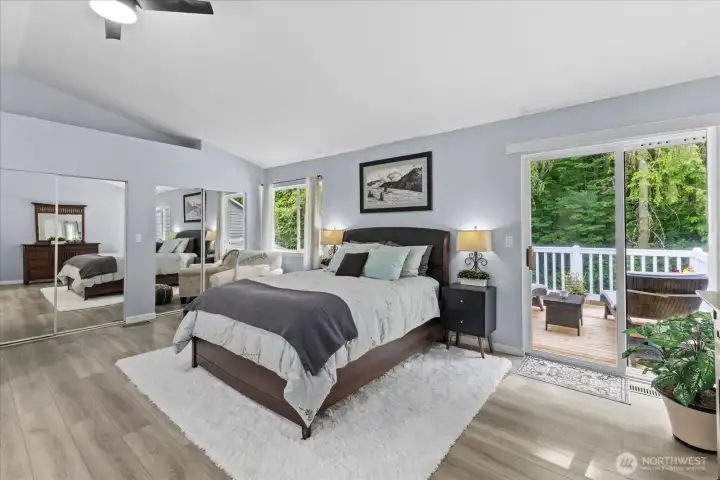 Primary bedroom retreat featuring an expansive layout bathed in natural light. This sanctuary includes double-wide, deep closets for generous storage, private deck access for quiet morning coffee, and serene views overlooking the adjacent greenbelt for maximum privacy Primary bedroom retreat featuring an expansive layout bathed in natural light. This sanctuary includes double-wide, deep closets for generous storage, private deck access for quiet morning coffee, and serene views overlooking the adjacent greenbelt for maximum privacy