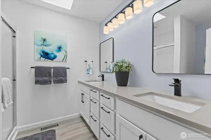 Remodeled ensuite featuring double undermount sinks, elegant quartz countertops, custom cabinetry, and a spacious walk-in shower. Remodeled ensuite featuring double undermount sinks, elegant quartz countertops, custom cabinetry, and a spacious walk-in shower.