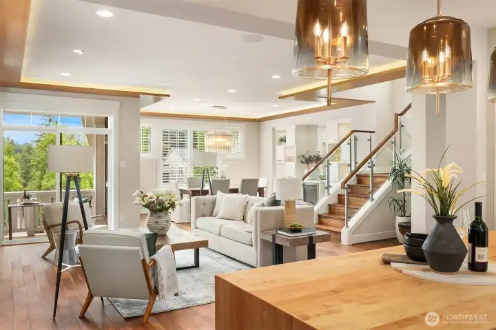 The heart of the home was designed for effortless living and entertaining, where the chef's kitchen, dining room, and great room flow together beneath custom architectural soffits with ambient lighting. Warm walnut flooring, glass railings, handcrafted wood accents, and carefully curated finishes create a space that feels both timeless and inviting, while the covered balcony extends everyday living outdoors. The heart of the home was designed for effortless living and entertaining, where the chef's kitchen, dining room, and great room flow together beneath custom architectural soffits with ambient lighting. Warm walnut flooring, glass railings, handcrafted wood accents, and carefully curated finishes create a space that feels both timeless and inviting, while the covered balcony extends everyday living outdoors.