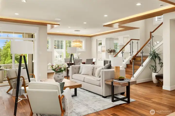 Every detail was thoughtfully considered—from the custom wood soffit ceilings with ambient lighting to the striking glass staircase, wide-plank hardwoods, and beautifully integrated built-ins. The result is a space that's equal parts architectural statement and everyday sanctuary. Every detail was thoughtfully considered—from the custom wood soffit ceilings with ambient lighting to the striking glass staircase, wide-plank hardwoods, and beautifully integrated built-ins. The result is a space that's equal parts architectural statement and everyday sanctuary.