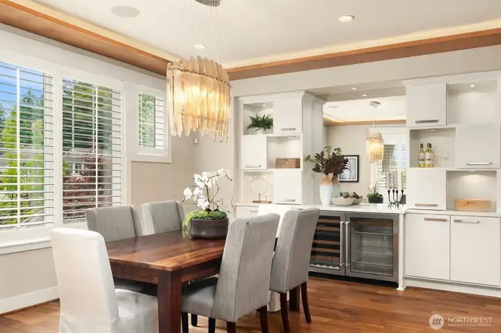 Designed to entertain beautifully, this dining room is anchored by a striking glass chandelier and complemented by custom built-ins, quartz countertops, and a dedicated wine and beverage center. Designed to entertain beautifully, this dining room is anchored by a striking glass chandelier and complemented by custom built-ins, quartz countertops, and a dedicated wine and beverage center.
