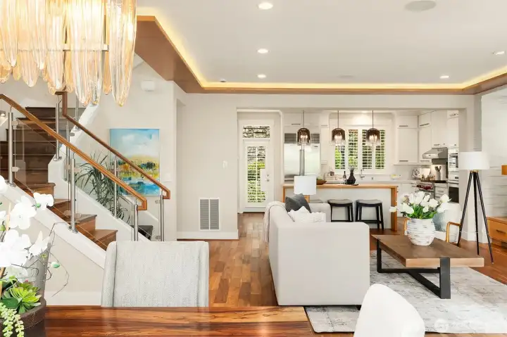 Open by design and elevated by craftsmanship. Rich hardwoods, architectural wood accents, glass railings, custom cabinetry, and natural stone create a main living space where every detail contributes to the whole. Open by design and elevated by craftsmanship. Rich hardwoods, architectural wood accents, glass railings, custom cabinetry, and natural stone create a main living space where every detail contributes to the whole.