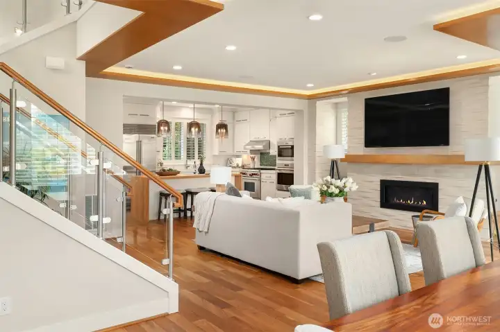 Open by design and elevated by craftsmanship. Rich hardwoods, architectural wood accents, glass railings, custom cabinetry, and natural stone create a main living space where every detail contributes to the whole. Open by design and elevated by craftsmanship. Rich hardwoods, architectural wood accents, glass railings, custom cabinetry, and natural stone create a main living space where every detail contributes to the whole.