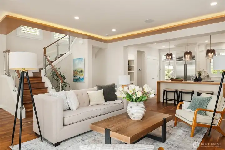 Open, inviting, and beautifully connected. Glass railings, rich hardwood floors, custom wood soffits with ambient lighting, and a chef's kitchen create a space designed for gathering and everyday living. Open, inviting, and beautifully connected. Glass railings, rich hardwood floors, custom wood soffits with ambient lighting, and a chef's kitchen create a space designed for gathering and everyday living.