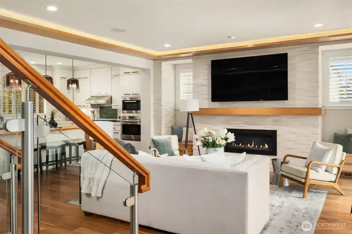 A carefully curated palette of walnut, natural stone, glass, and crisp white millwork creates a timeless architectural statement. From the striking glass staircase to the stacked stone fireplace and chef's kitchen beyond, every detail was designed to feel beautifully connected. A carefully curated palette of walnut, natural stone, glass, and crisp white millwork creates a timeless architectural statement. From the striking glass staircase to the stacked stone fireplace and chef's kitchen beyond, every detail was designed to feel beautifully connected.